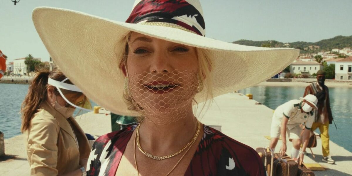 Still from Glass Onion in which Kate Hudson as Birdie Jay is wearing a useless mesh face mask